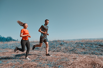 Image showing couple jogging in a healthy lifestyle on a fresh mountain air