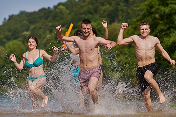 Image showing group of happy friends having fun on river