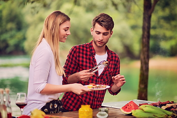 Image showing friends having picnic french dinner party outdoor during summer holiday