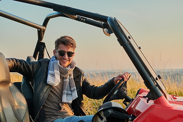 Image showing man enjoying beautiful sunny day while driving a off road buggy car