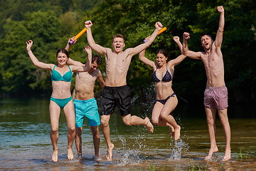 Image showing group of happy friends having fun on river