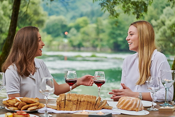 Image showing girlfriends having picnic french dinner party outdoor