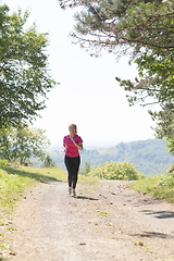 Image showing woman enjoying in a healthy lifestyle while jogging