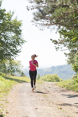 Image showing woman enjoying in a healthy lifestyle while jogging