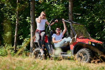 Image showing couple enjoying beautiful sunny day while driving a off road buggy