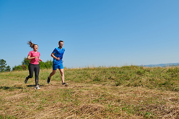 Image showing couple jogging in a healthy lifestyle on a fresh mountain air