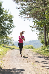 Image showing woman enjoying in a healthy lifestyle while jogging