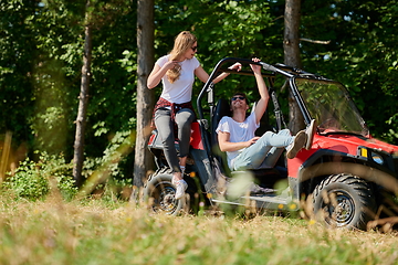 Image showing couple enjoying beautiful sunny day while driving a off road buggy