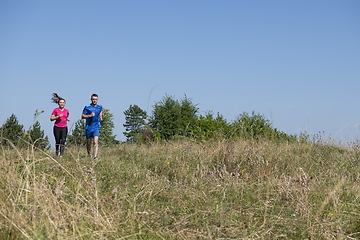 Image showing couple jogging in a healthy lifestyle on a fresh mountain air