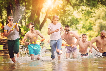 Image showing group of happy friends having fun on river