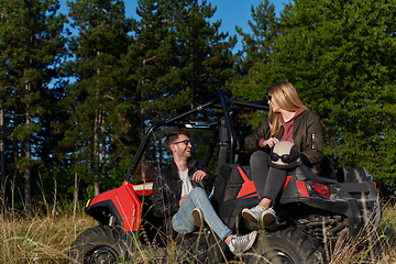 Image showing couple enjoying beautiful sunny day while driving a off road buggy