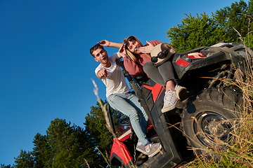 Image showing couple enjoying beautiful sunny day while driving a off road buggy