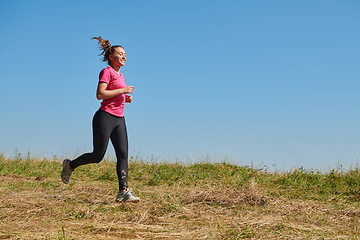 Image showing woman enjoying in a healthy lifestyle while jogging