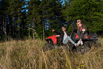 Image showing couple enjoying beautiful sunny day while driving a off road buggy