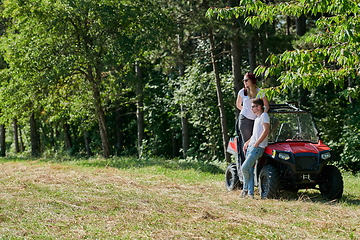 Image showing couple enjoying beautiful sunny day while driving a off road buggy