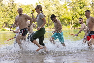 Image showing group of happy friends having fun on river