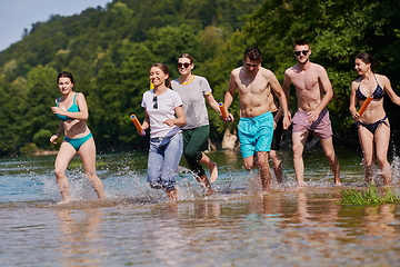 Image showing group of happy friends having fun on river