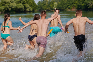 Image showing group of happy friends having fun on river