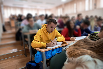 Image showing student taking notes while studying in high school