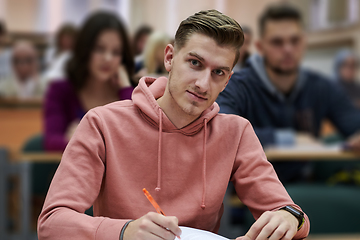 Image showing student taking notes while studying in high school