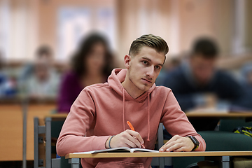 Image showing student taking notes while studying in high school