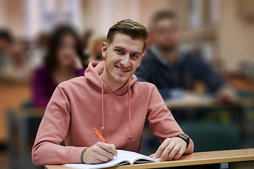 Image showing student taking notes while studying in high school