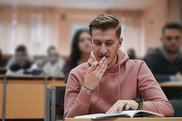 Image showing student taking notes while studying in high school