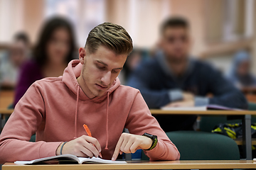 Image showing student taking notes while studying in high school