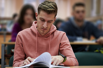 Image showing student taking notes while studying in high school