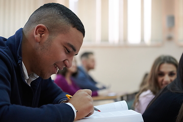 Image showing student taking notes while studying in high school