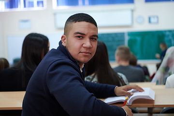 Image showing student taking notes while studying in high school