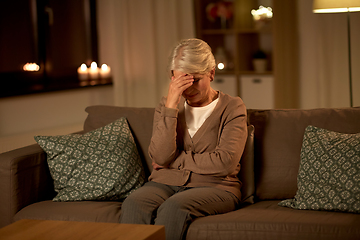 Image showing unhappy senior woman suffering from headache