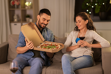 Image showing happy couple eating takeaway pizza at home