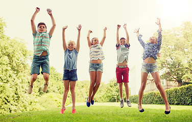 Image showing happy kids jumping and having fun in summer park