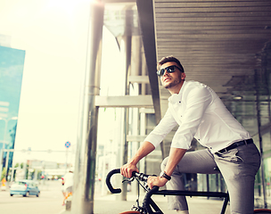 Image showing man with bicycle and headphones on city street