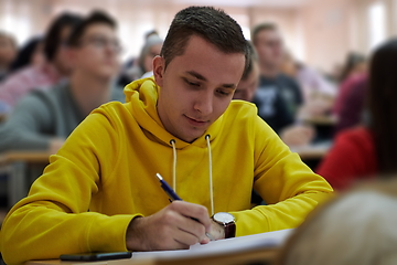 Image showing student taking notes while studying in high school