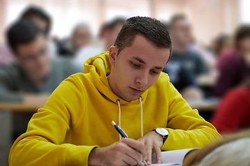 Image showing student taking notes while studying in high school