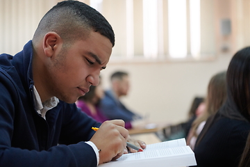 Image showing student taking notes while studying in high school