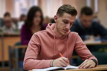 Image showing student taking notes while studying in high school