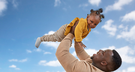 Image showing happy african american father with baby over sky