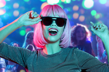 Image showing woman in wig and sunglasses dancing at nightclub