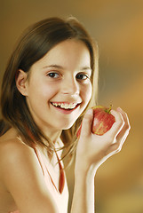 Image showing A girl with an apple