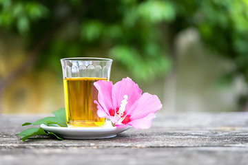 Image showing Mallow tea with blossom on old wooden background