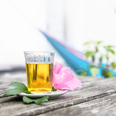 Image showing Mallow tea with blossom on old wooden background