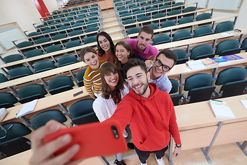 Image showing Group of multiethnic teenagers taking a selfie in school