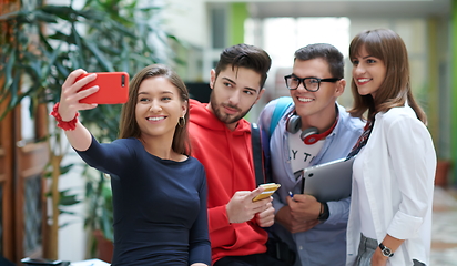 Image showing Group of multiethnic teenagers taking a selfie in school