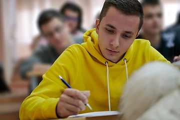 Image showing student taking notes while studying in high school