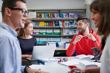 Image showing students group working on school project together on tablet computer at modern university