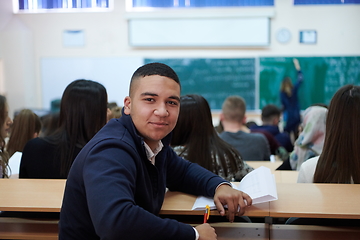 Image showing student taking notes while studying in high school