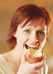 Image showing A woman with an apple